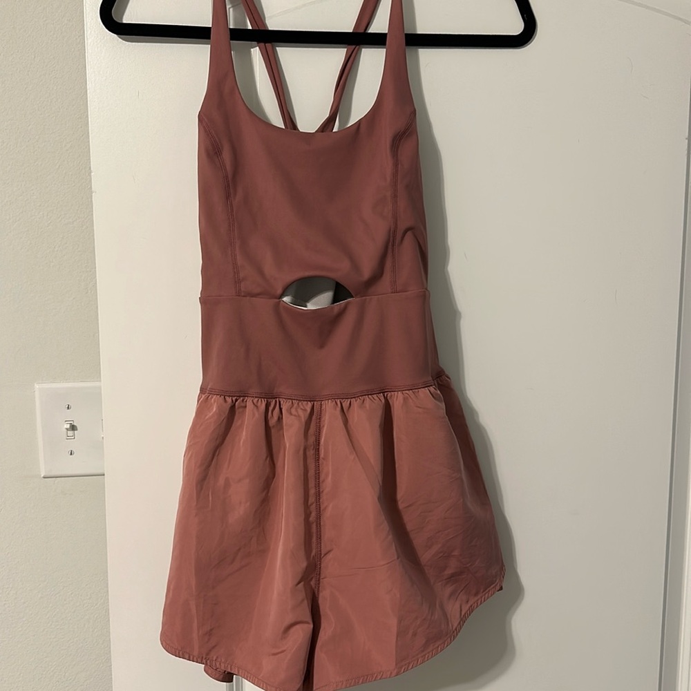 Athletic style boutique romper with cutout, color mauve